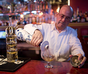 Armado pours up a healthy shot of Clase Azul Añejo, which Grover consumed, along with a shot of Sangrita.